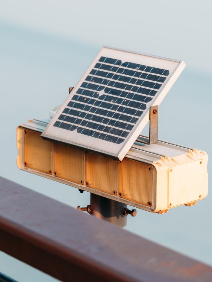 Close-up of a solar panel mounted on a metal support outdoors in daylight.